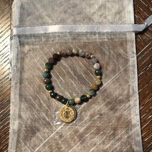 Earth tone beaded bracelet with gold charm